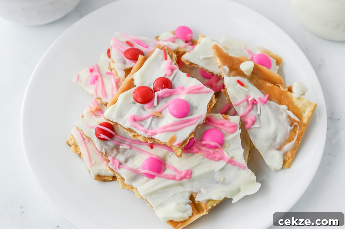 Valentine's Day cracker candy broken up into chunks on a white plate.