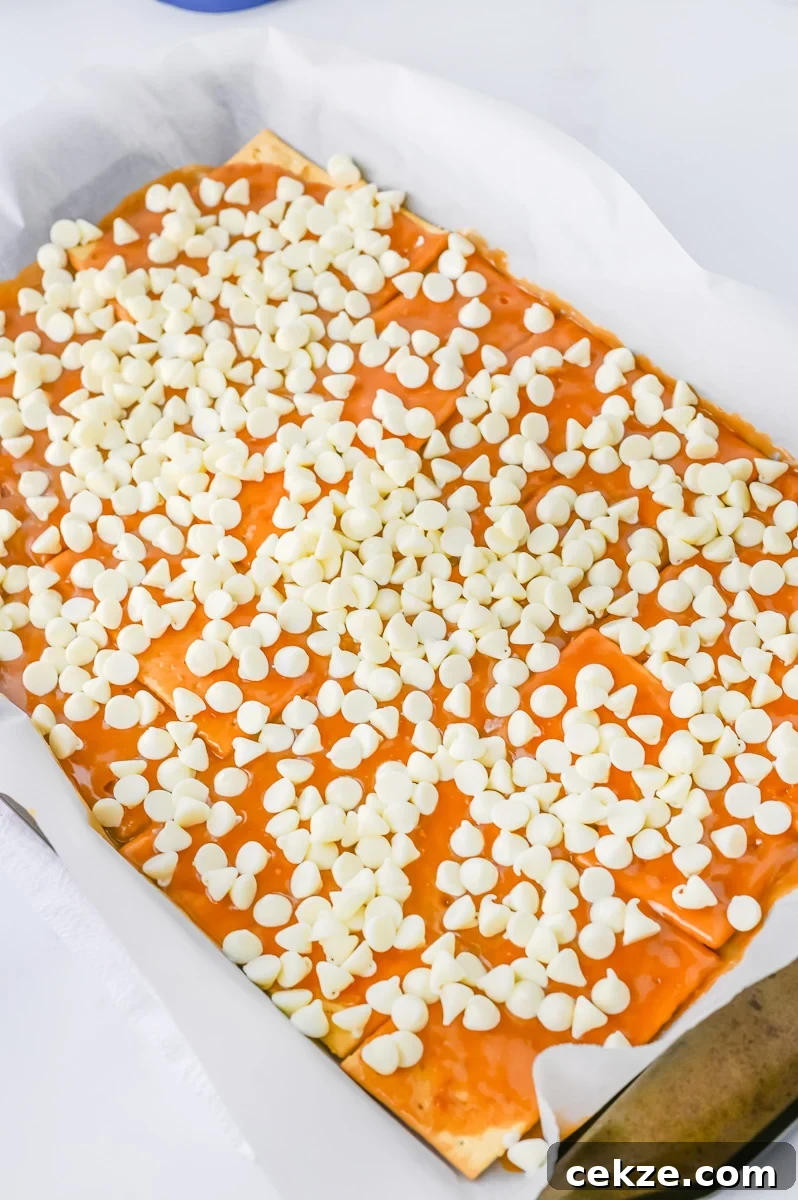 White chocolate chips are spread ont top of brown sugar mixture.
