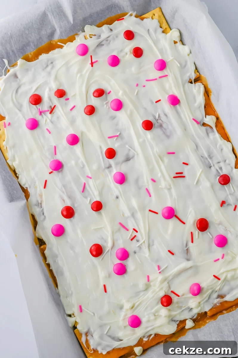 Valentine's M&M candies and Valentine's Day sprinkles are sprinkled on top of the white chocolate.