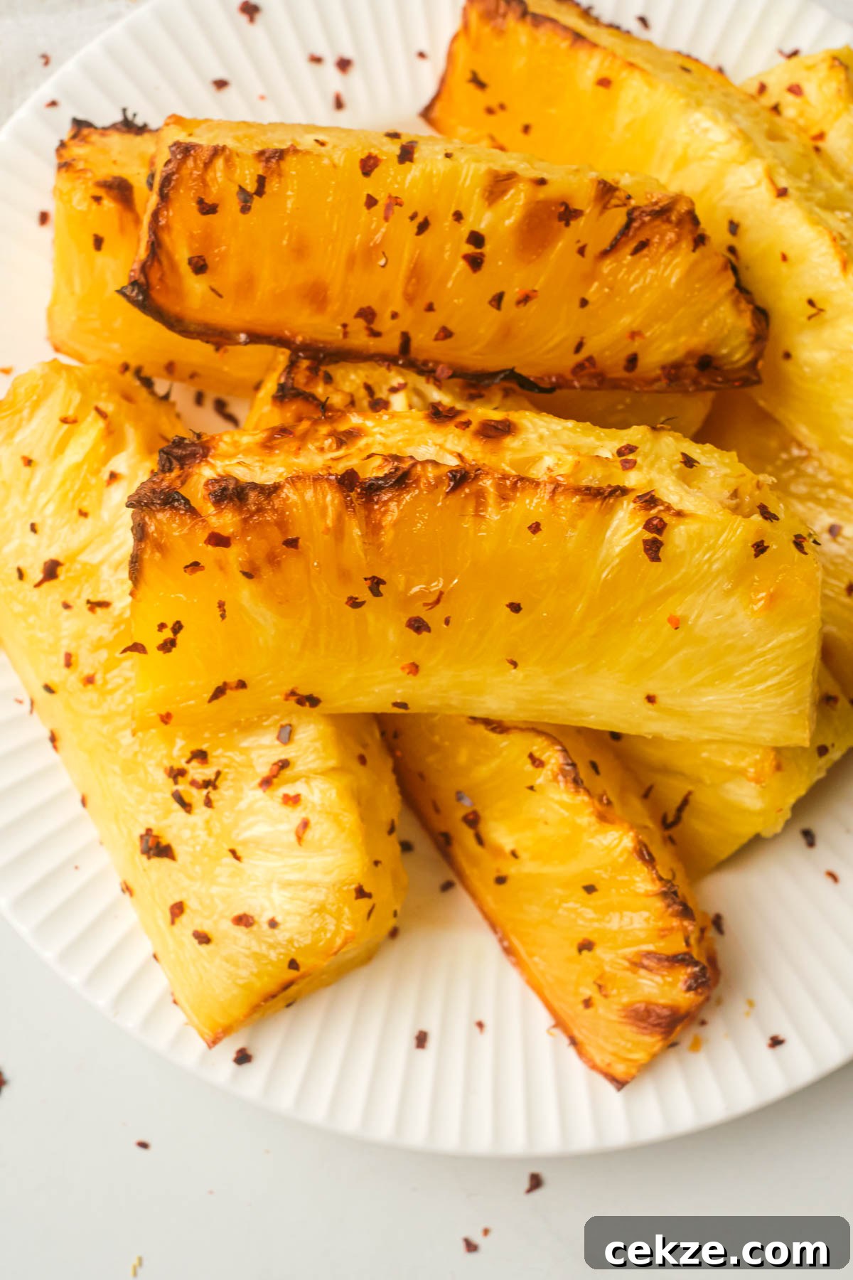 close up view of the finished air fryer pineapple on a white plate