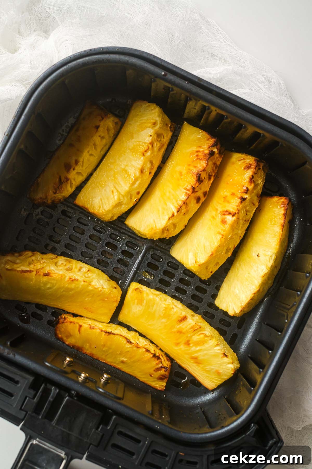 top down view of pineapple in air fryer basket