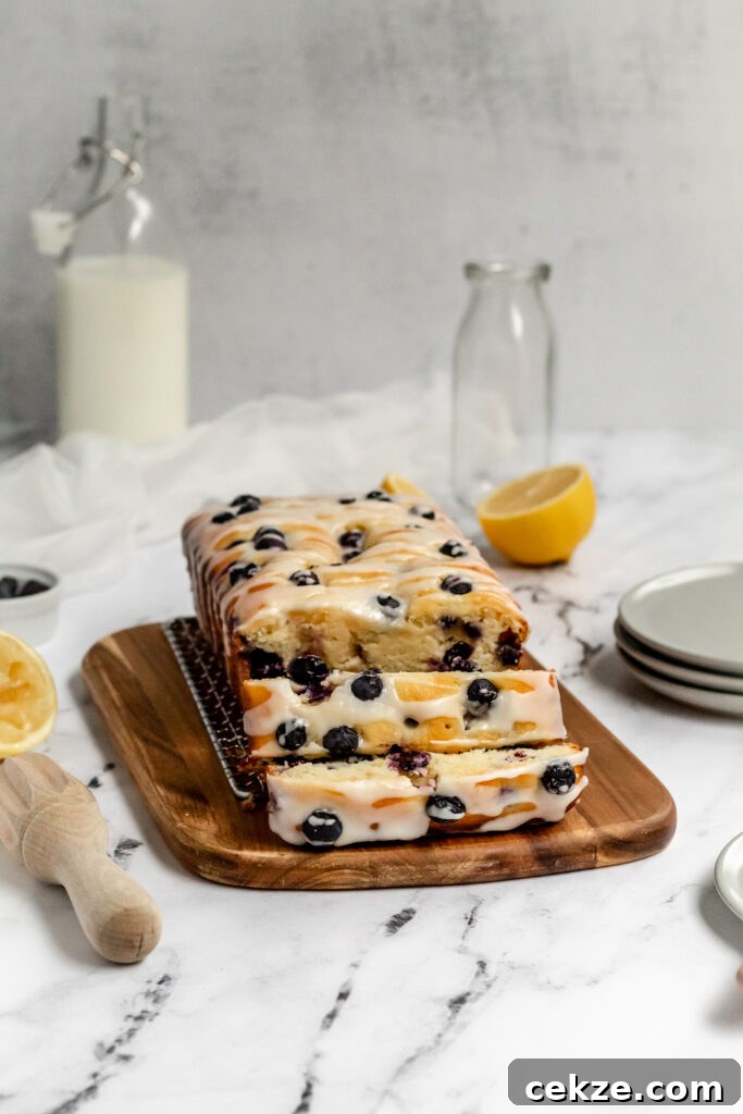 Ricotta pound cake topped and filled with blueberries and cut into thick slices.
