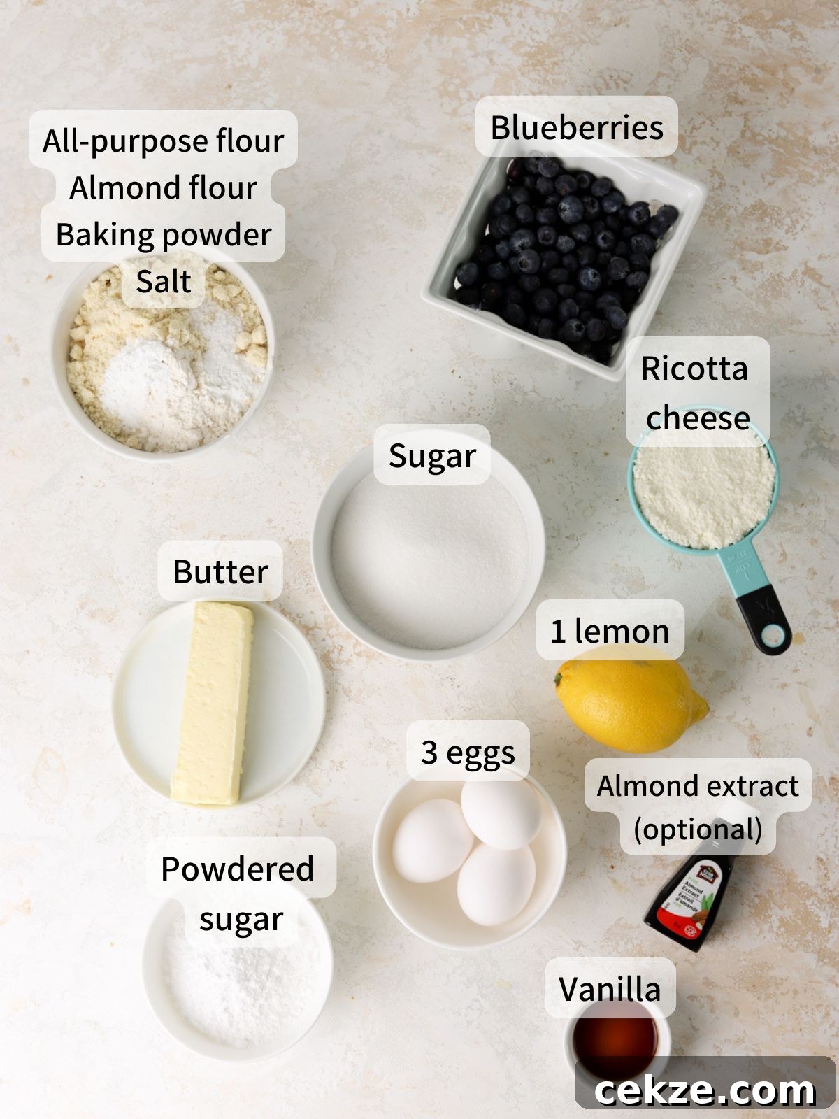 Labeled ingredients needed to make blueberry ricotta pound cake laid out on a table.