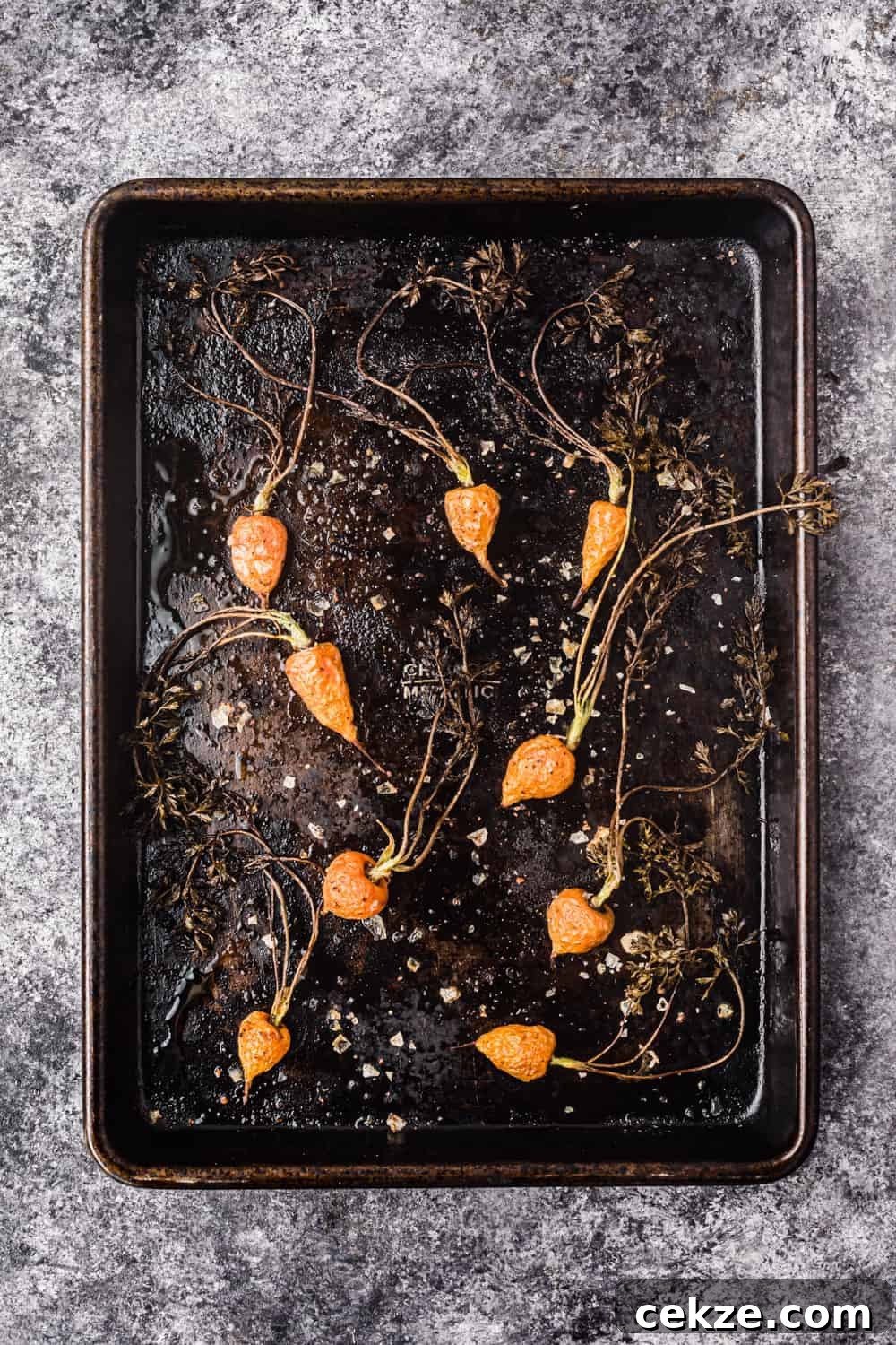baking tray with roasted baby carrots, flaky sea salt and pepper to be used in the farmers market salad