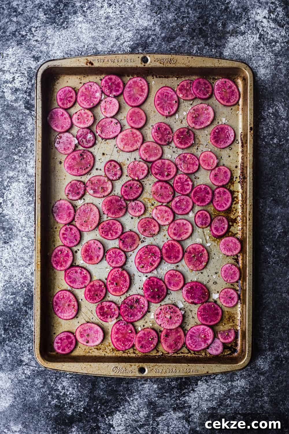 baking sheet with pink potatoes thinly sliced, overhear shot to be used in the farmers market salad