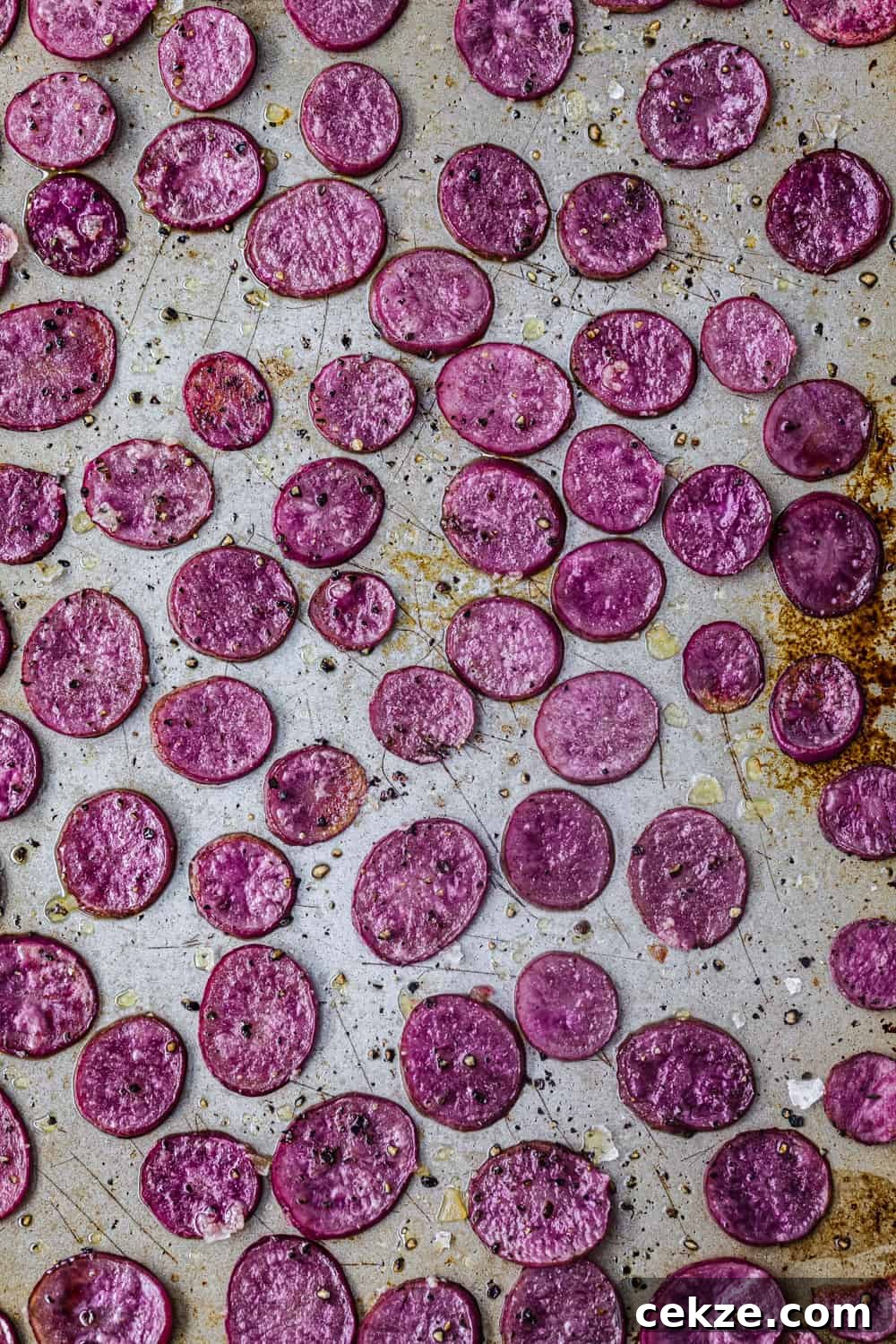 Up close shot of pink potatoes all roasted, just out of the oven, to be used in the farmers market salad