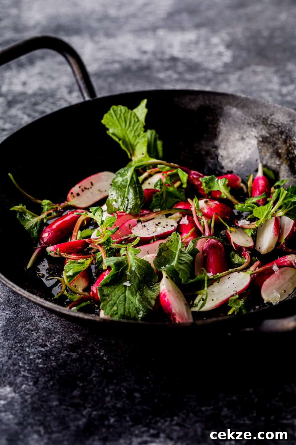 side angle shot of raw radishes in a little skillet to be used in the farmers market salad