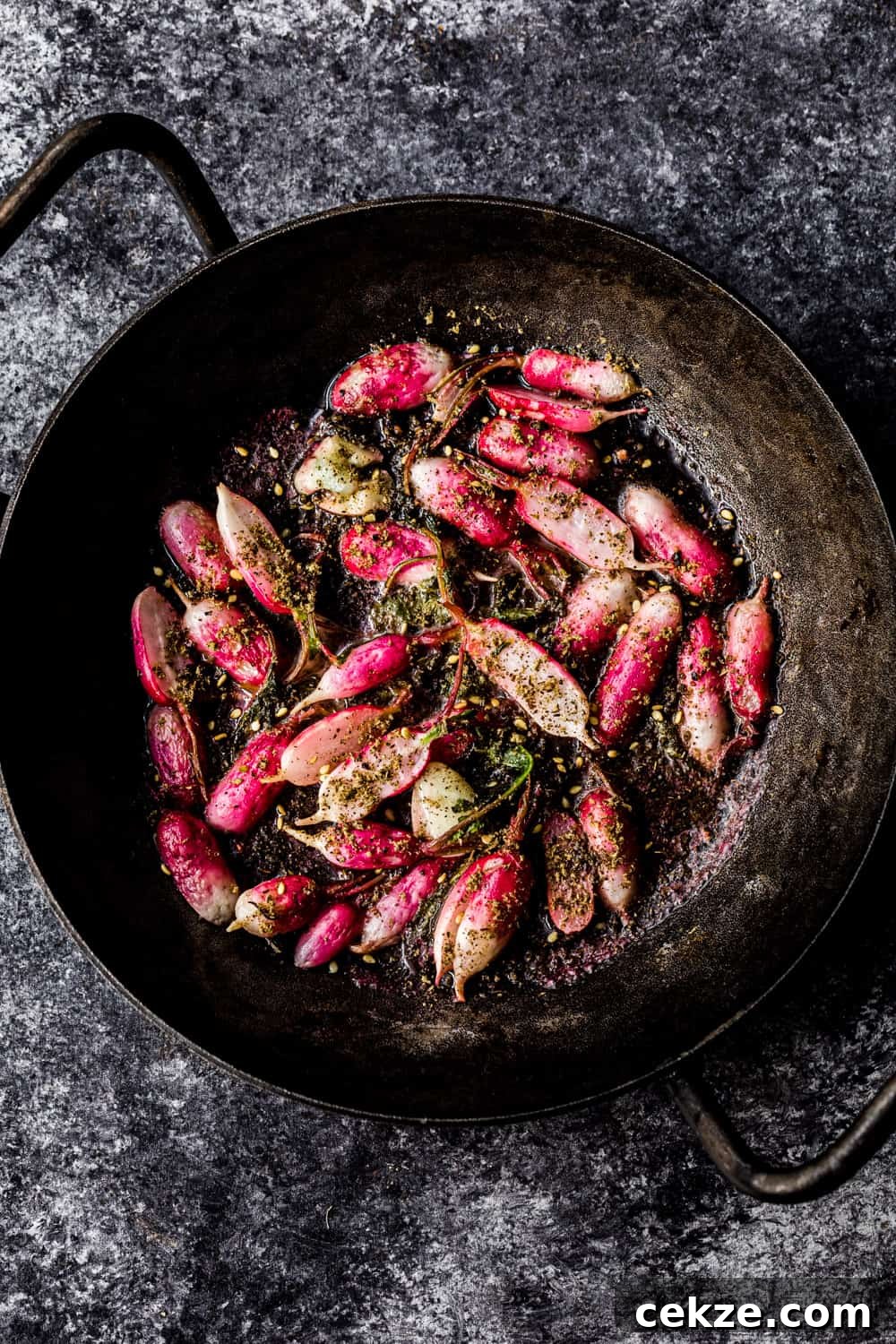 sauteed radishes in a skillet with za'atar, overhead shot to be used in the farmers market salad