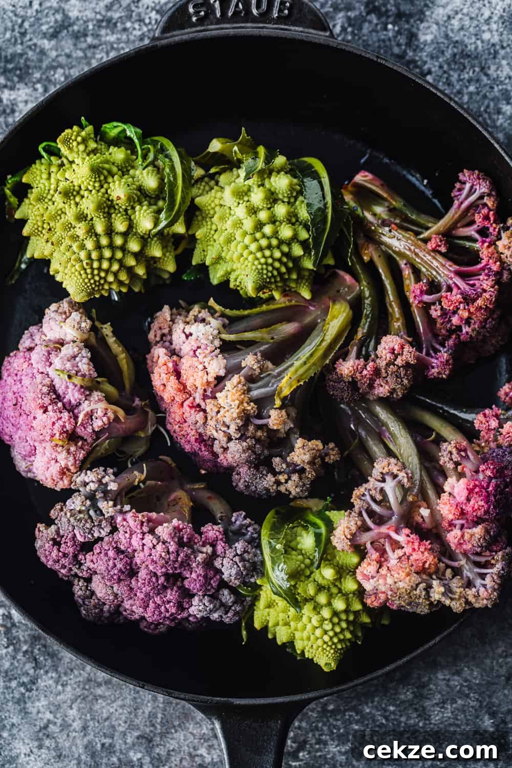 purple cauliflower and romensco in a cast iron skillet, pre-oven and overhead shot to be used in the farmers market salad