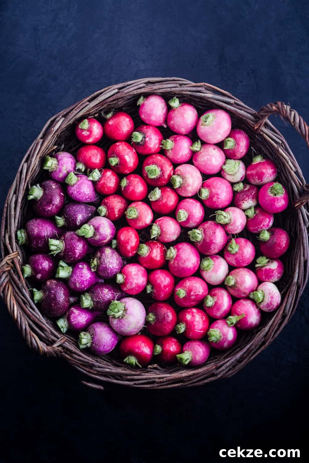 basked filled with red, purple and pink radishes, overheard shot