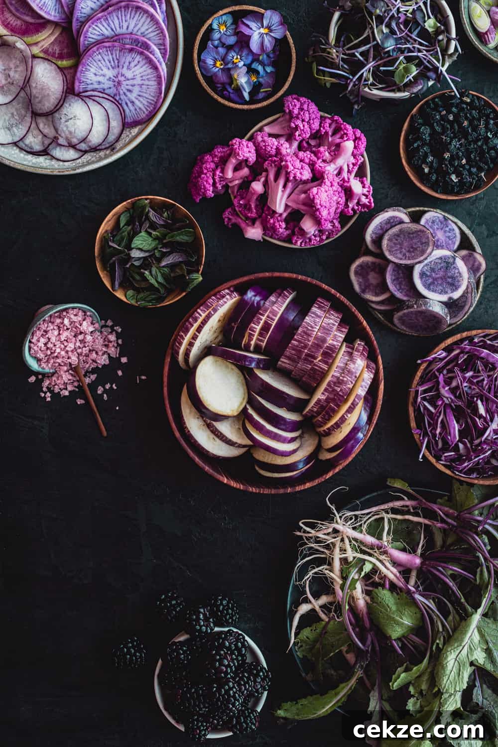 in process shot of farmers market salad in the mading with all purple fruits and veggies.