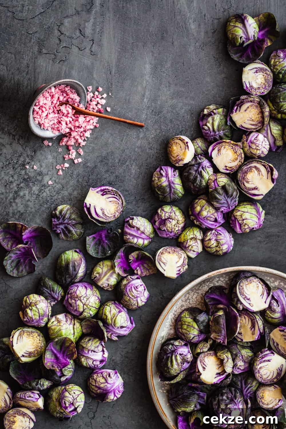 Brussels sprouts artfully arranged on a grey board.