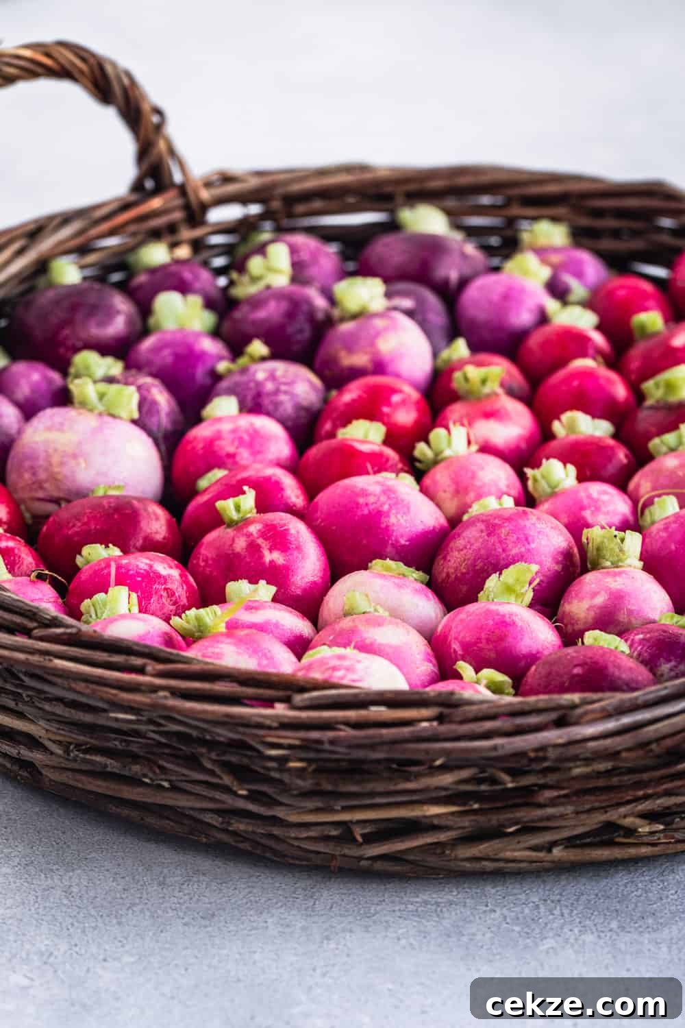 side angle shot of basket filled with farmers market fresh radishes