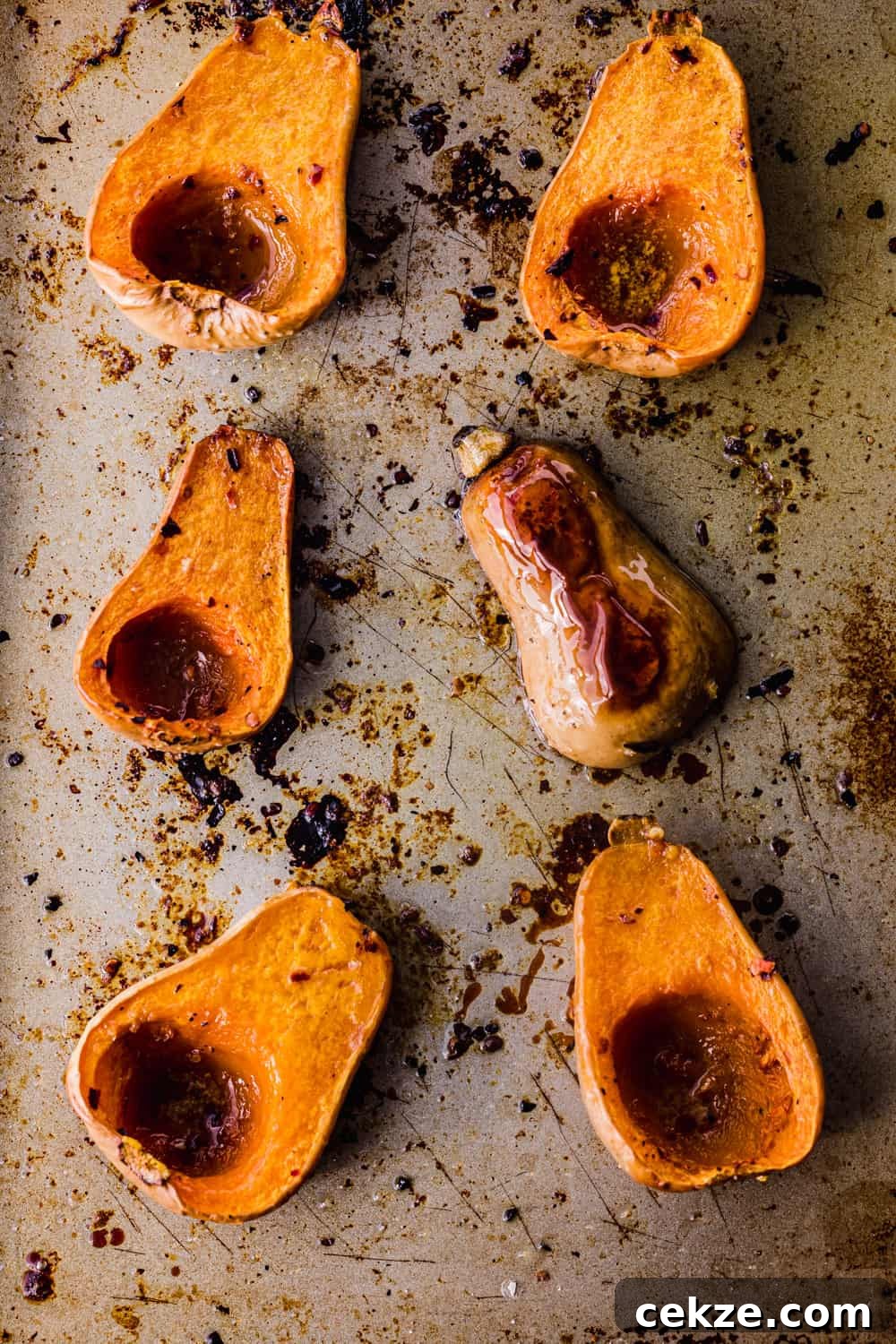 butternut squash, some cut side up and some cut side down, post being roasted in the oven to be used in the farmers market salad