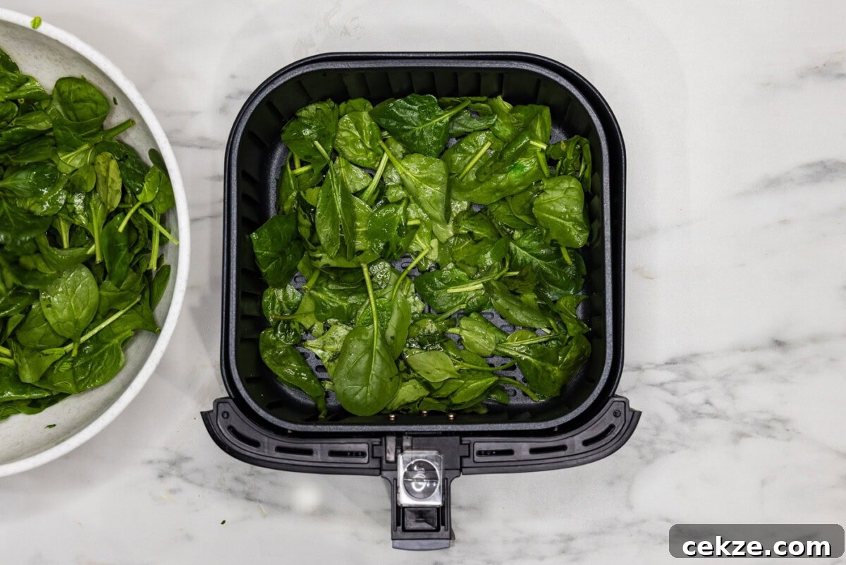 spinach in an air fryer basket