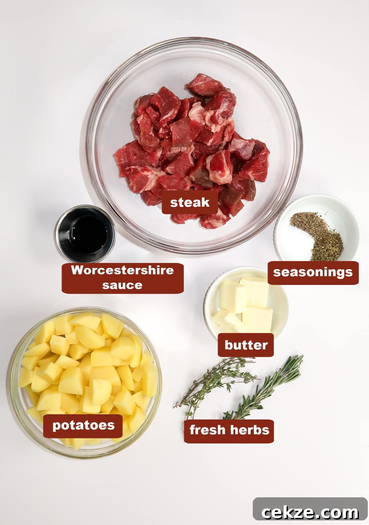 Garlic Butter Steak and Potatoes Skillet Recipe for Weeknights 2 All of the ingredients for steak and potatoes in bowls on a white countertop.