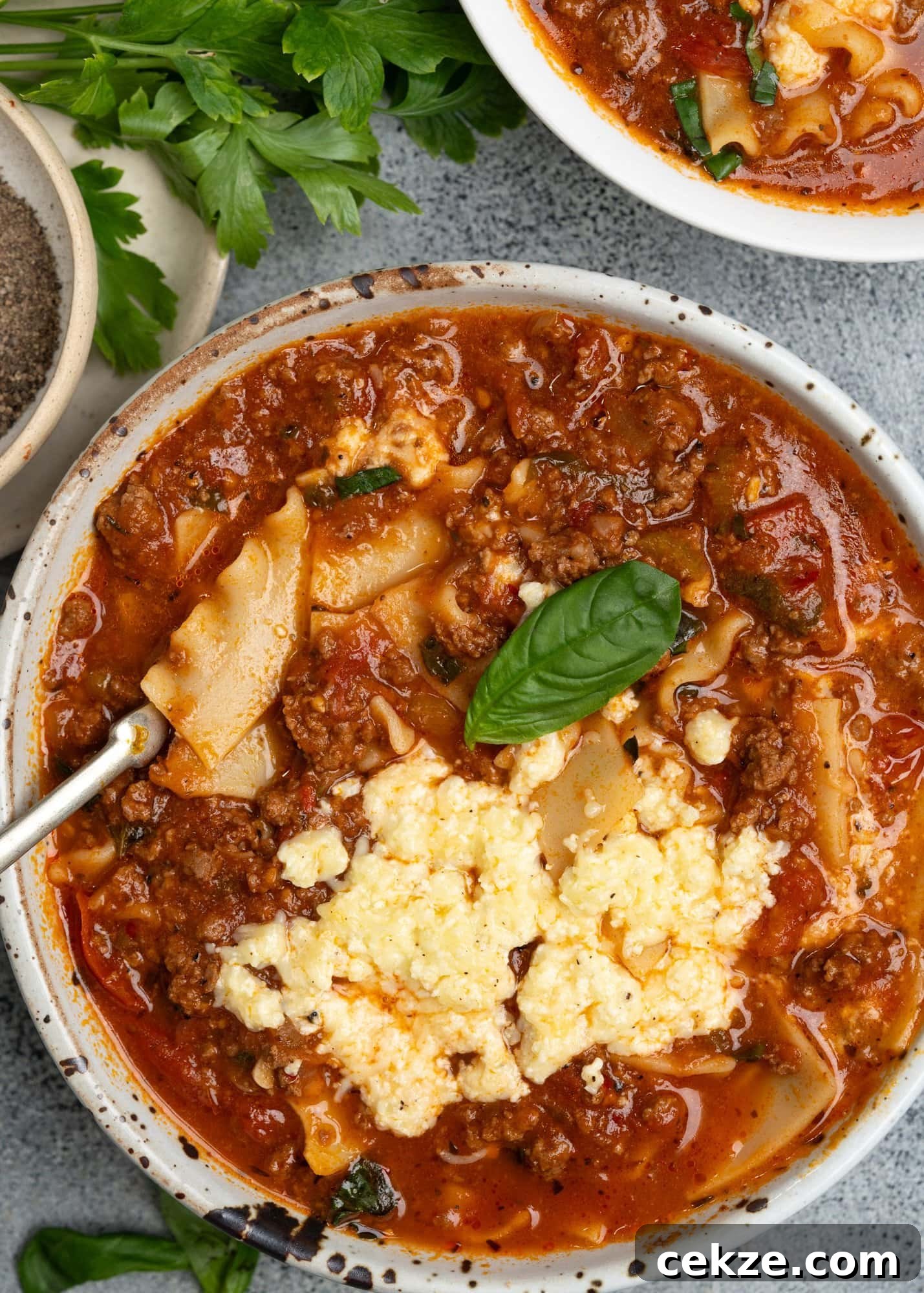 Hearty Lasagna Soup Recipe: Comfort in a Bowl 6 Lasagna soup served in a bowl topped with cheese mixture.