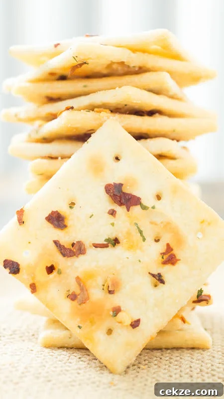 Fire Crackers Recipe (Saltines seasoned with ranch, and red pepper flakes) are stacked on top of one another.