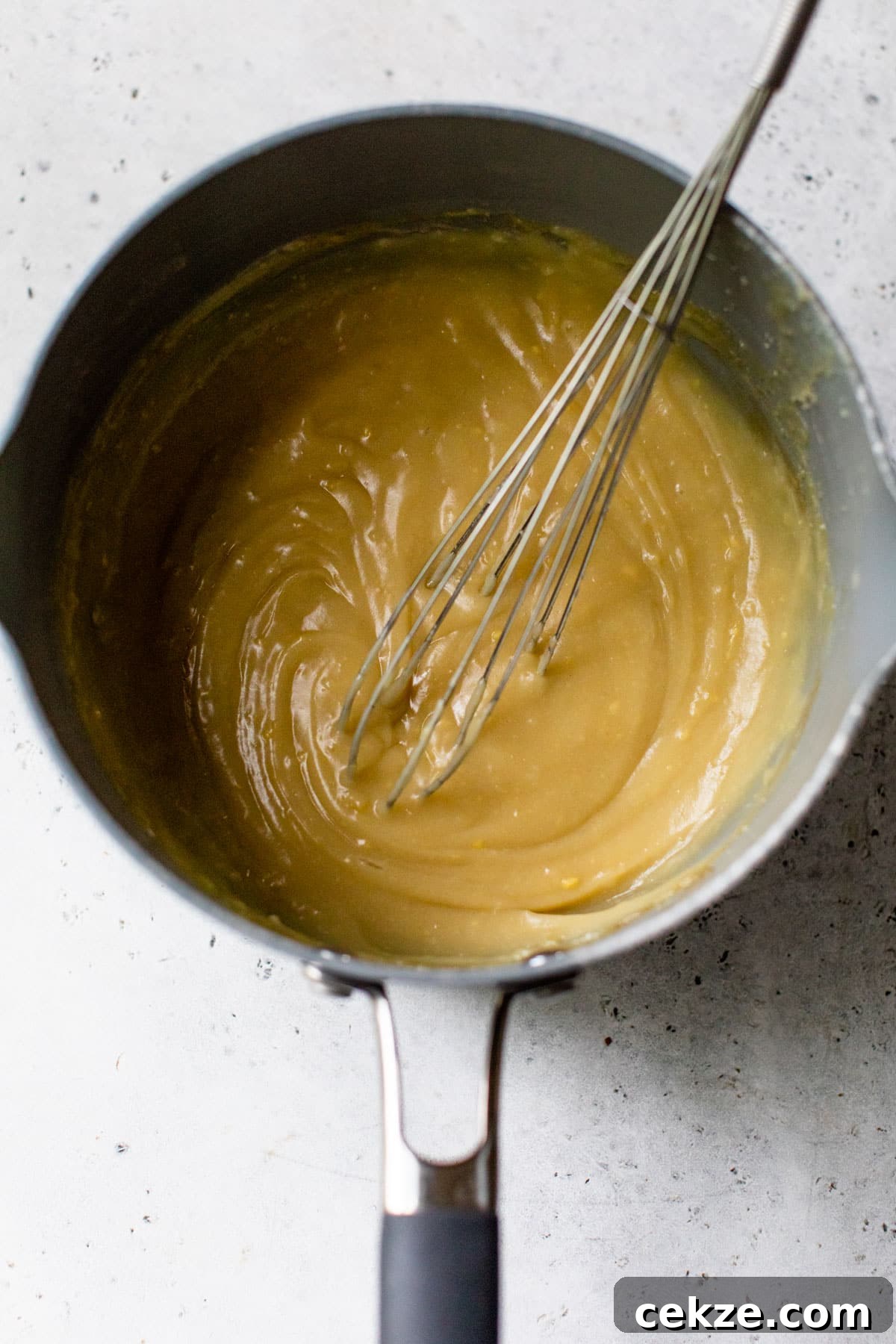 Creamy Banana Pudding Pie Recipe: Step-by-Step Dessert Guide 3 banana pudding in a saucepan with a whisk