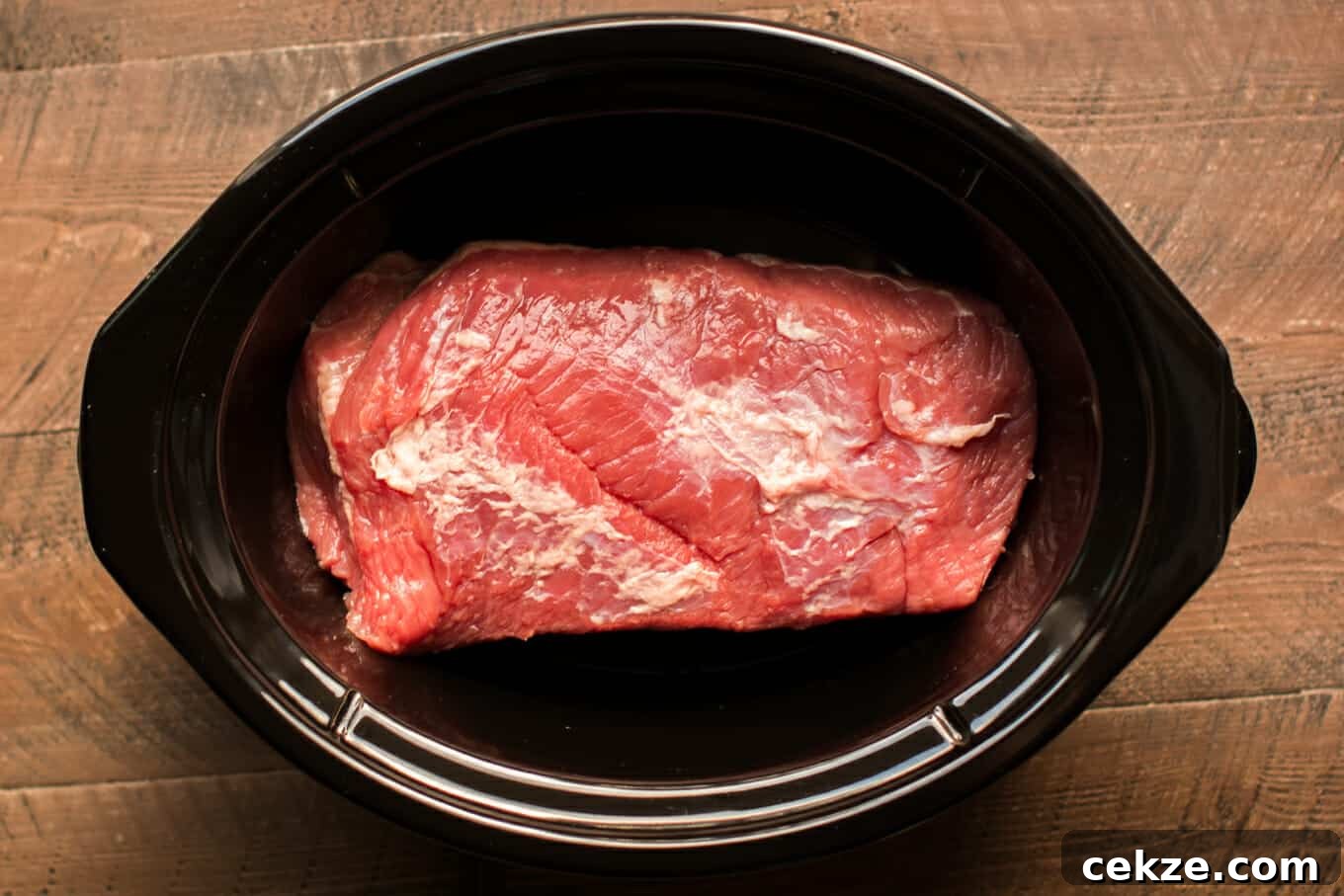 raw corned beef in a slow cooker