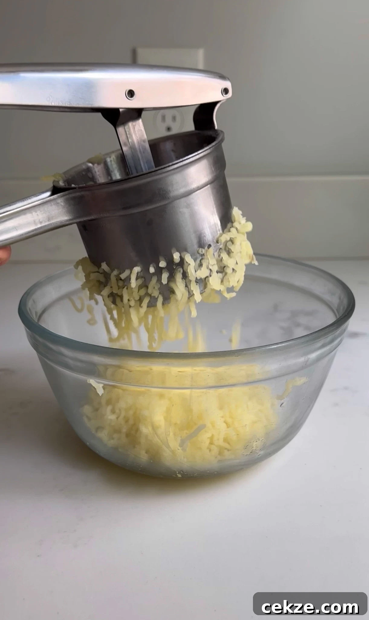 Ricing the potatoes for bread.
