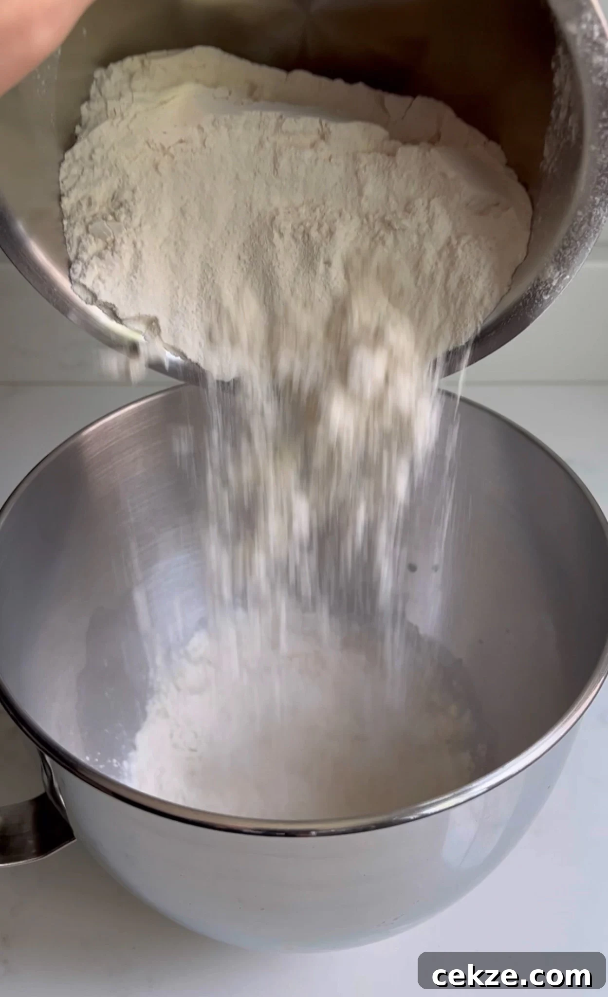 Adding flour to the dough.
