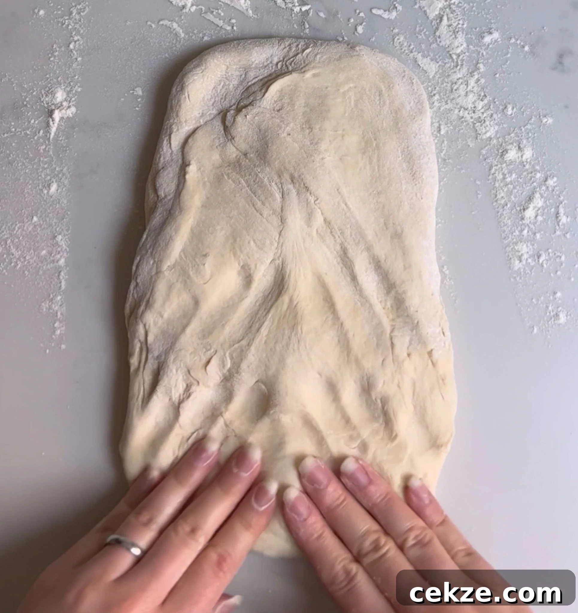 Pressing the dough into a rectangle.