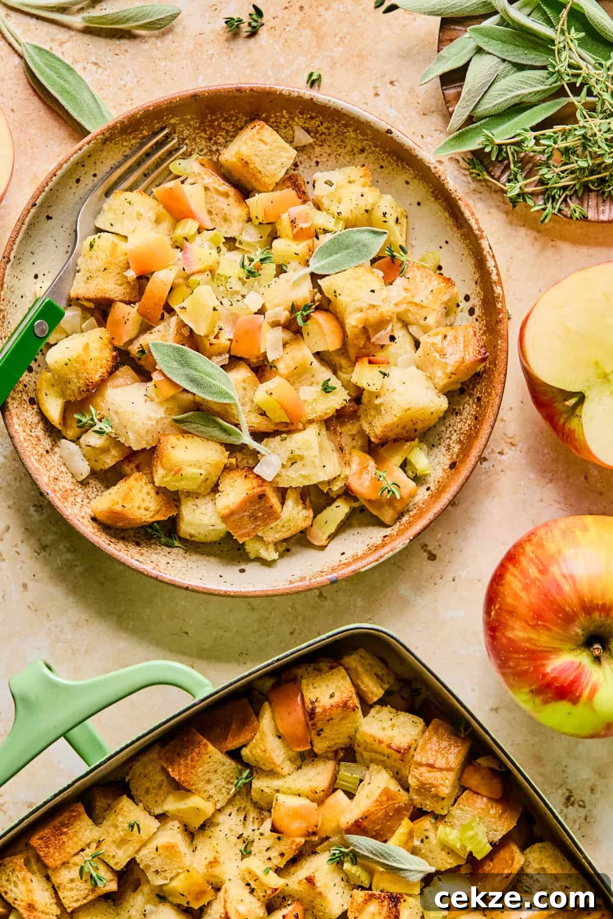Apple and Sage Stuffing Recipe with Crispy Herbs 14 Serving of apple sage bread stuffing on plate with pan nearby.