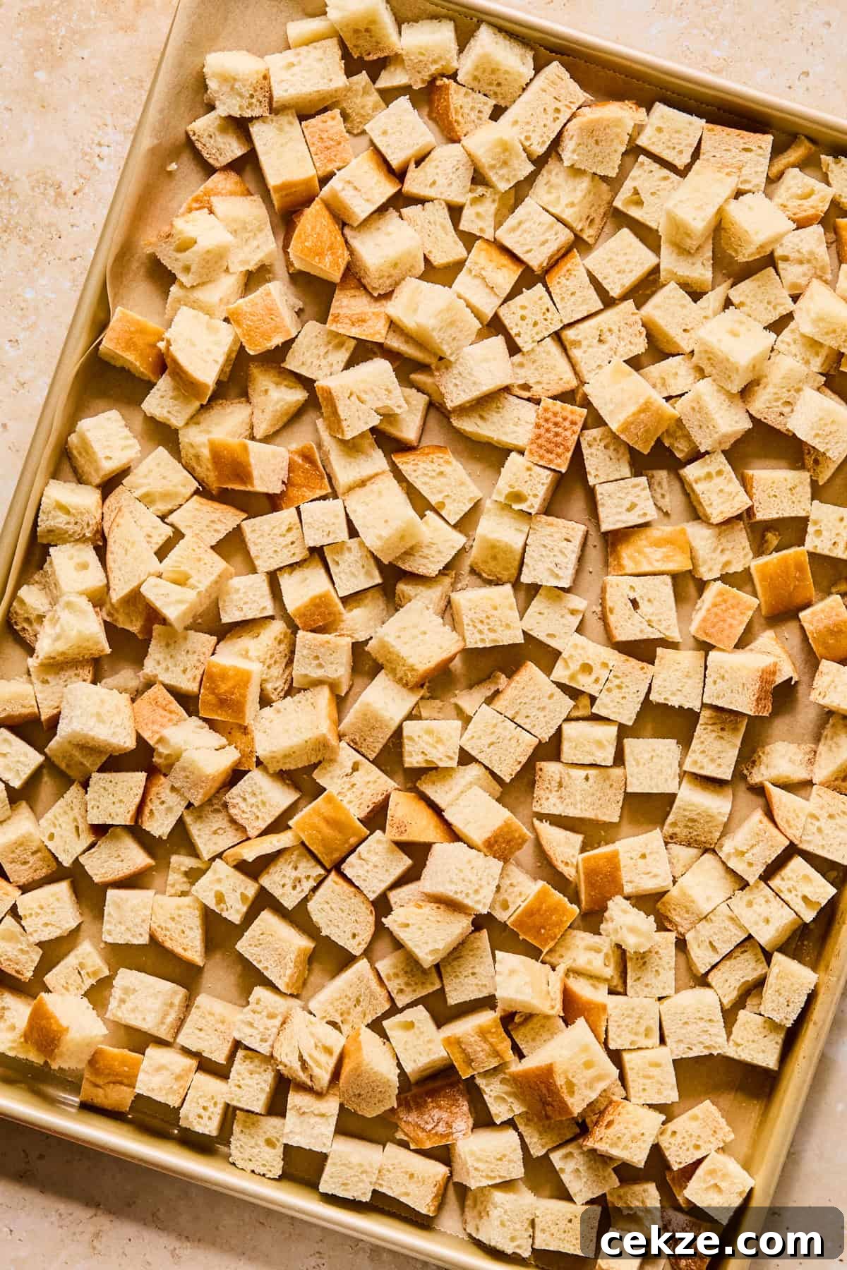 Apple and Sage Stuffing Recipe with Crispy Herbs 5 Bread cubes on sheet pan.