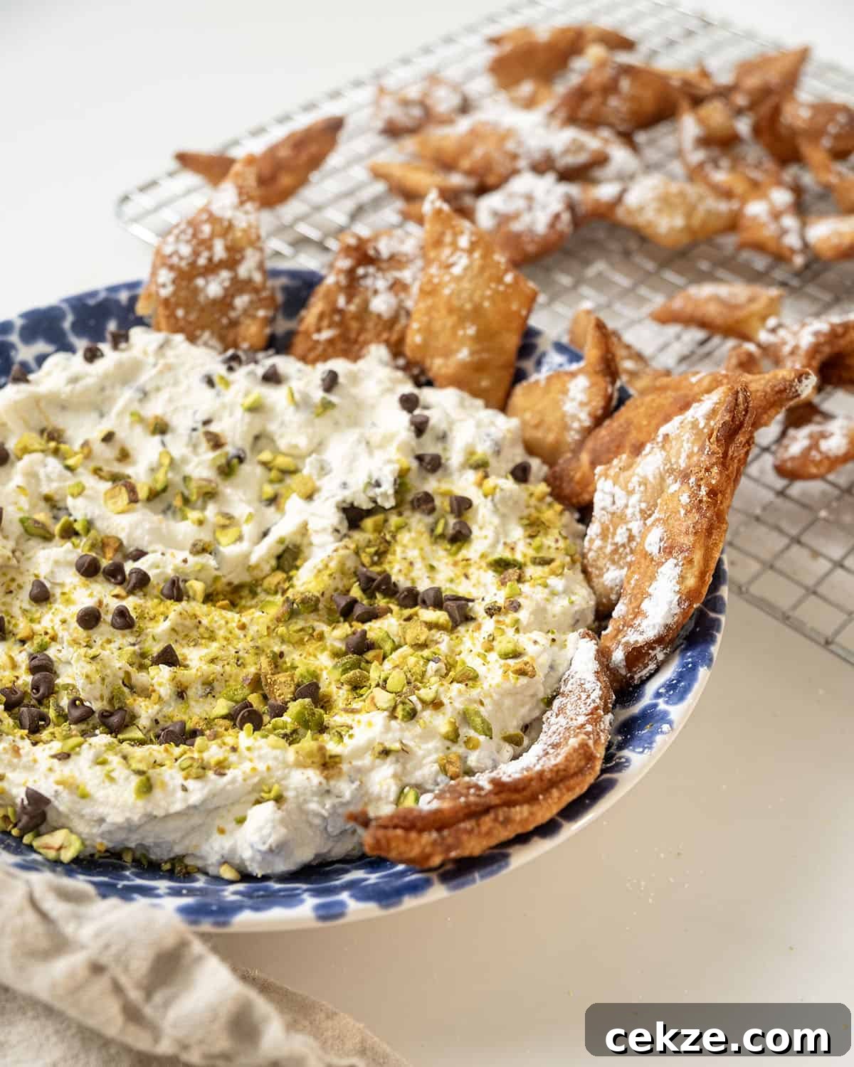 Authentic Cannoli Dip with Homemade Cannoli Chips 14 Homemade cannoli dip and chips in a dish.