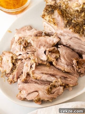 Sliced pork shoulder on a cutting board.