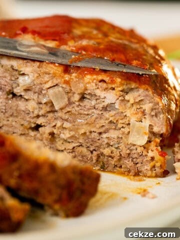 Italian meatloaf sliced on a plate.