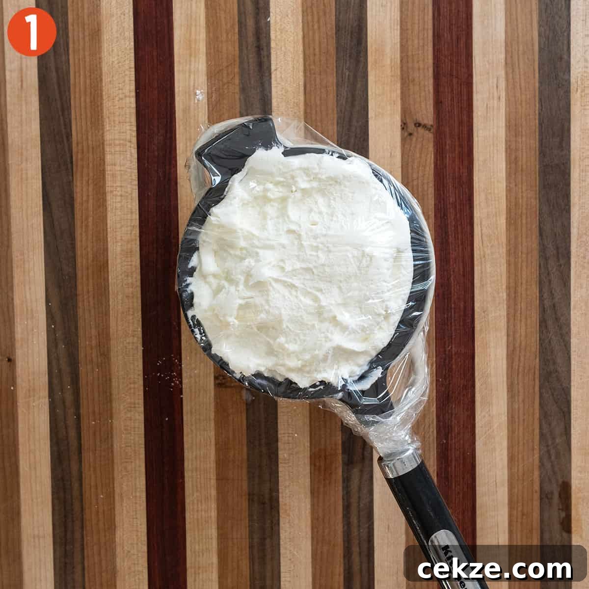 Authentic Cannoli Dip with Homemade Cannoli Chips 4 Draining ricotta in a mesh strainer.