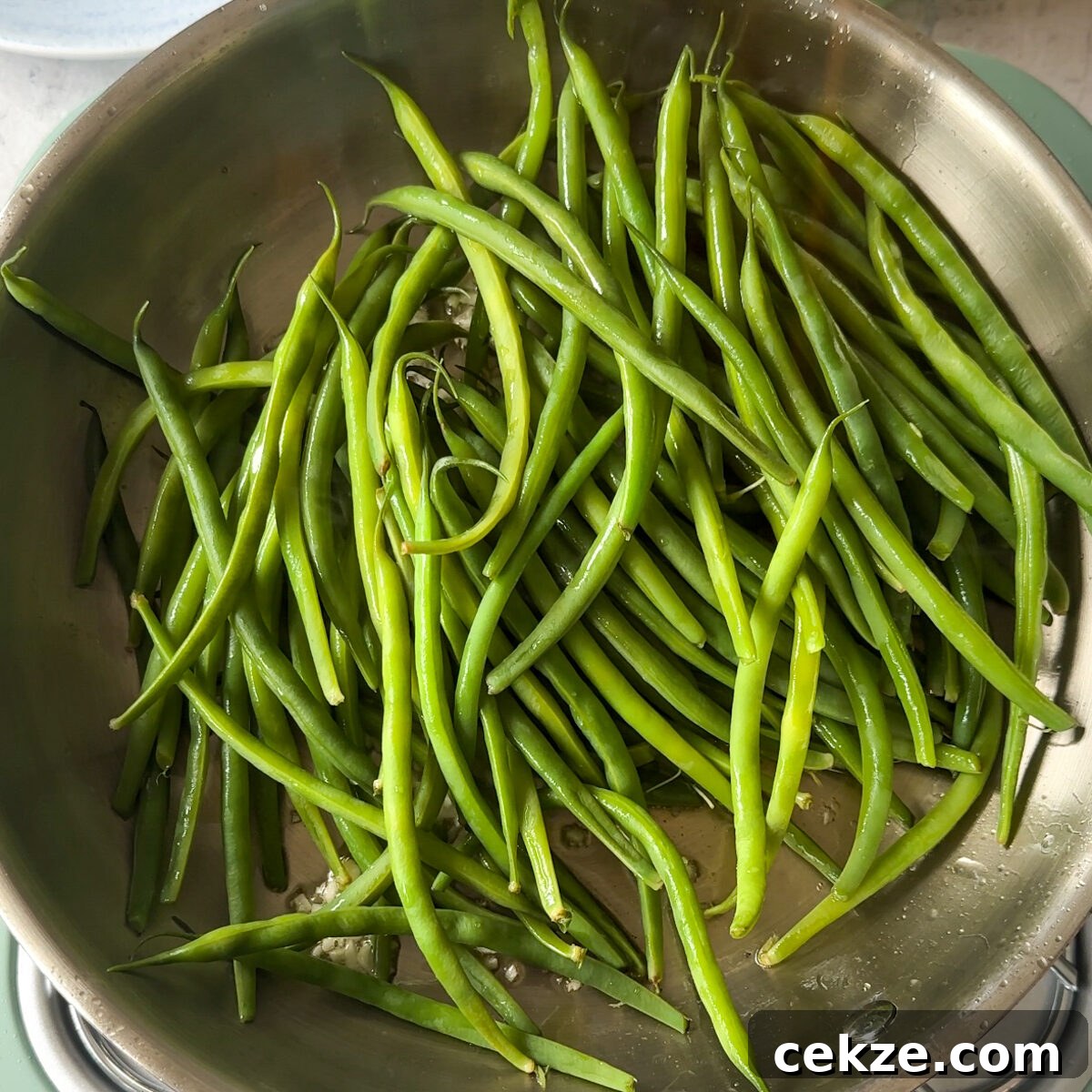 Set the salmon aside, & in the same pan, sauté the minced garlic & green beans!