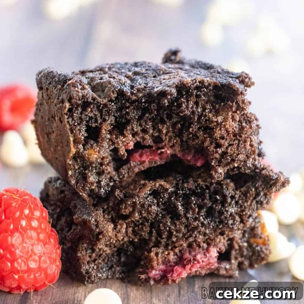 close up of two halves of the white chocolate raspberry brownies stacked
