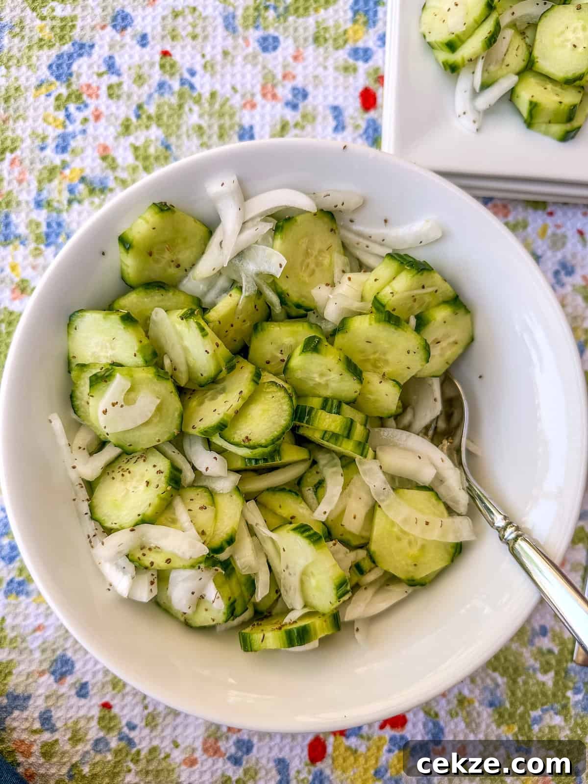 Crisp Quick Refrigerator Pickled Cucumbers in 30 Minutes 12 A serving bowl of sliced cucumbers and onions.