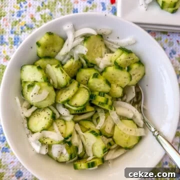 Crisp Quick Refrigerator Pickled Cucumbers in 30 Minutes 13 A serving bowl of sliced cucumbers and onions.