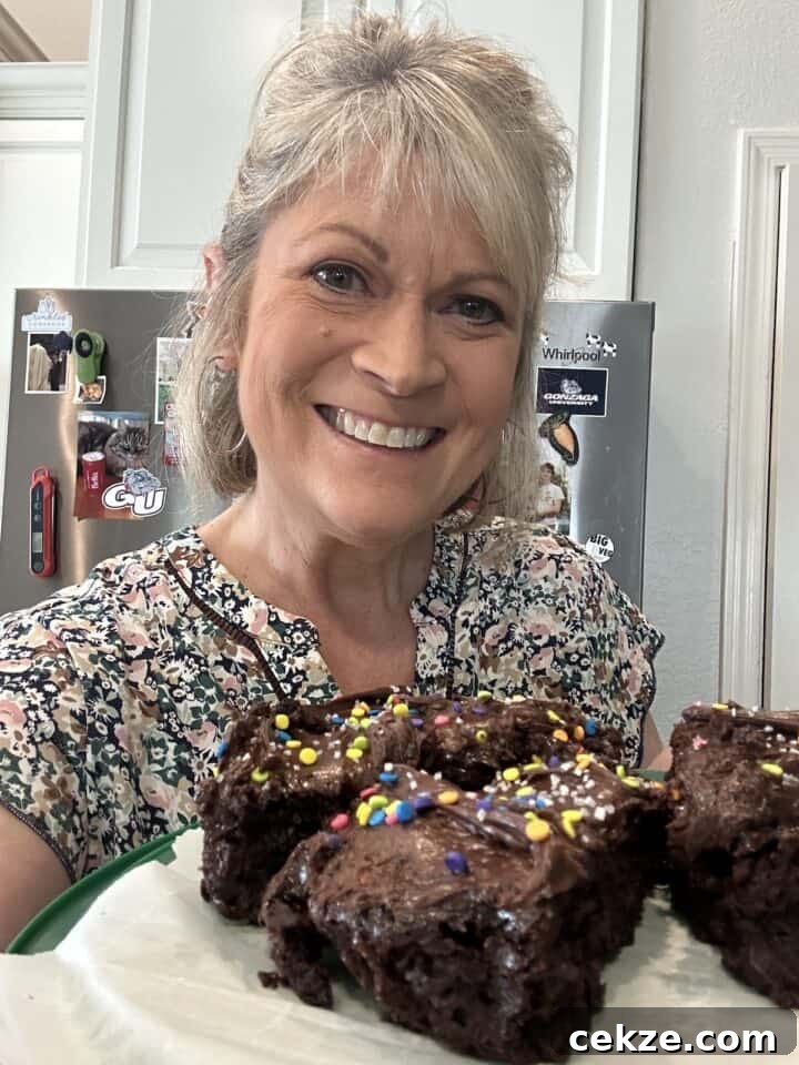 Crisp Quick Refrigerator Pickled Cucumbers in 30 Minutes 3 Melinda in the kitchen holding a plate of chocolate cake slices.