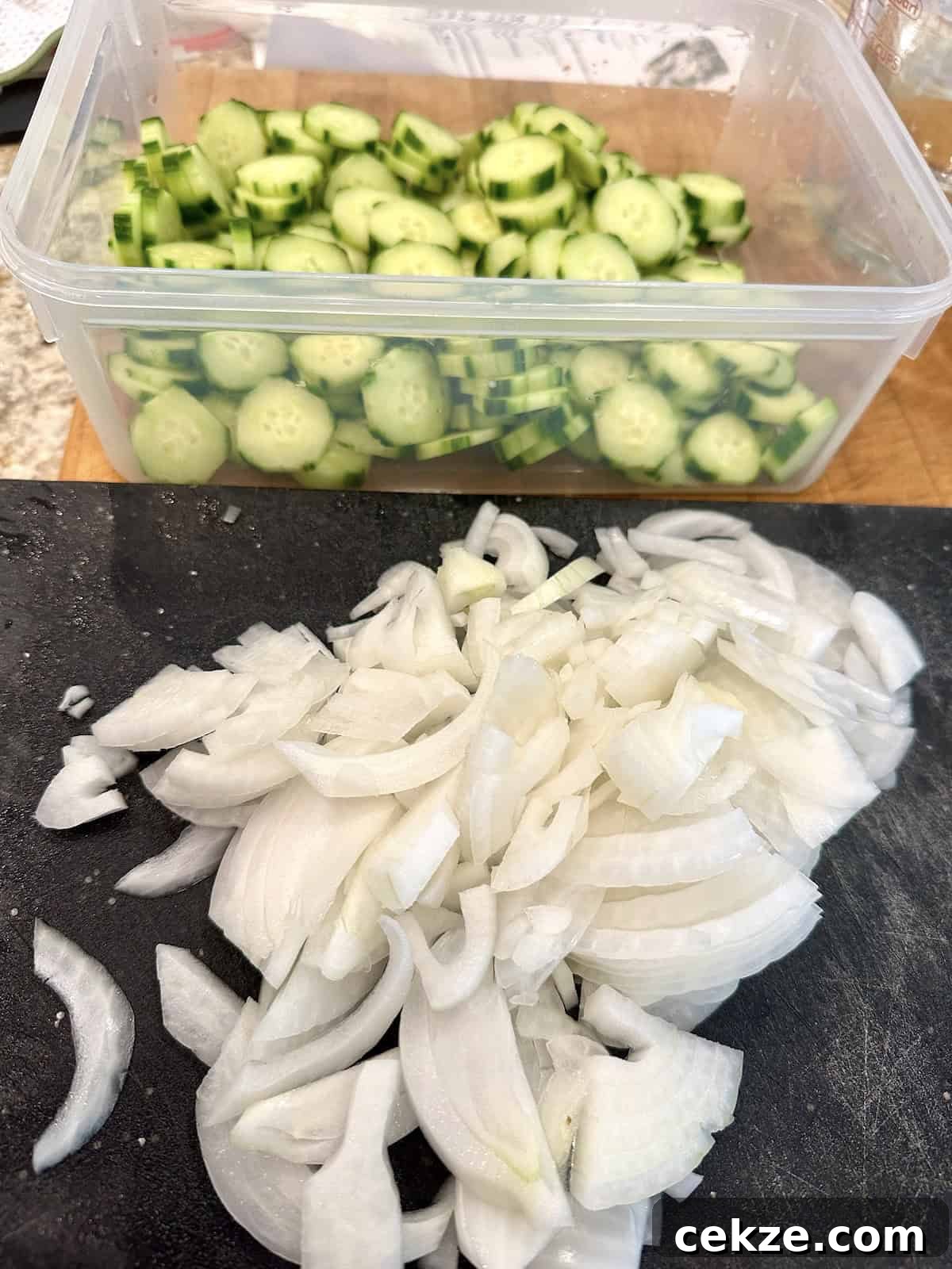 Crisp Quick Refrigerator Pickled Cucumbers in 30 Minutes 6 Sliced onions and cucumbers for refrigerator pickles.