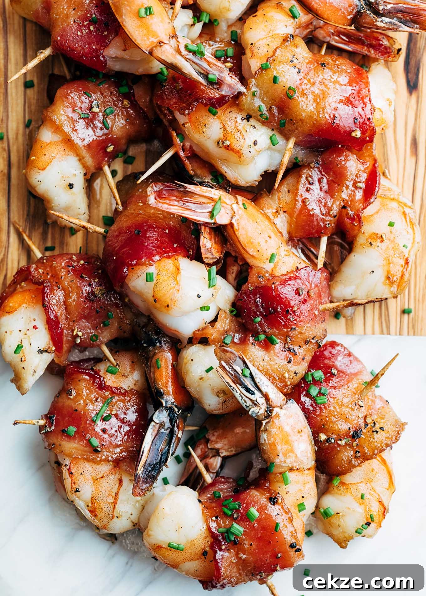 bourbon glazed bacon wrapped shrimp on a serving board