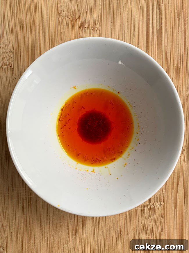 Instant Pot Zereshk Polo — Persian Barberry Rice Recipe 11 Saffron soaking in water in white bowl.