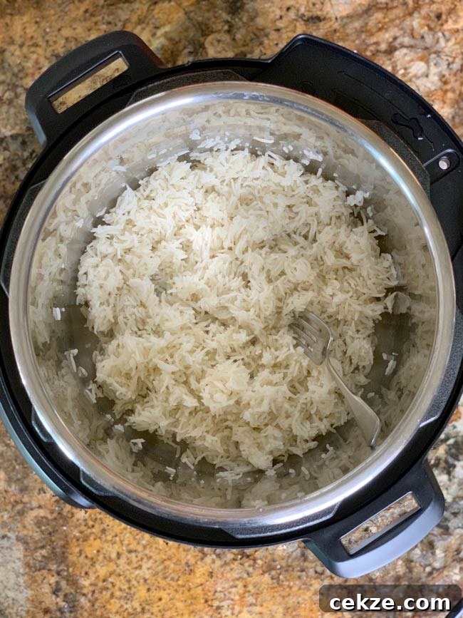 Instant Pot Zereshk Polo — Persian Barberry Rice Recipe 13 Cooked basmati rice in instant pot fluffed by fork.