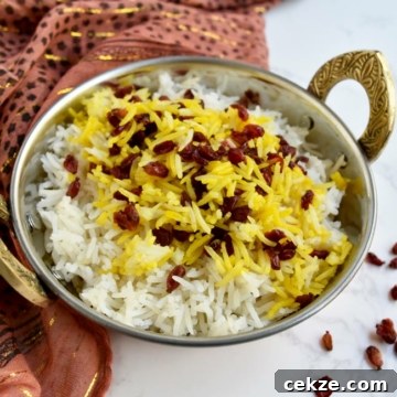 Instant Pot Zereshk Polo — Persian Barberry Rice Recipe 15 landscape view of saffron rice in copper bowl with gold scarf