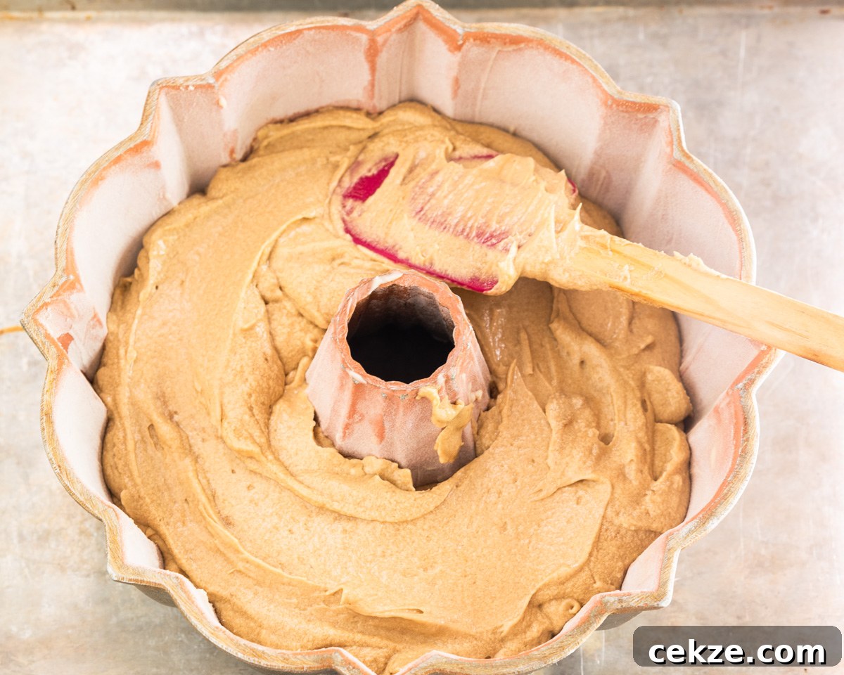 Authentic Cuban Rum Cake Recipe: Moist Drunken Cake with Rum Glaze 5 A bundt pan filled with cake batter. Hostess At Heart