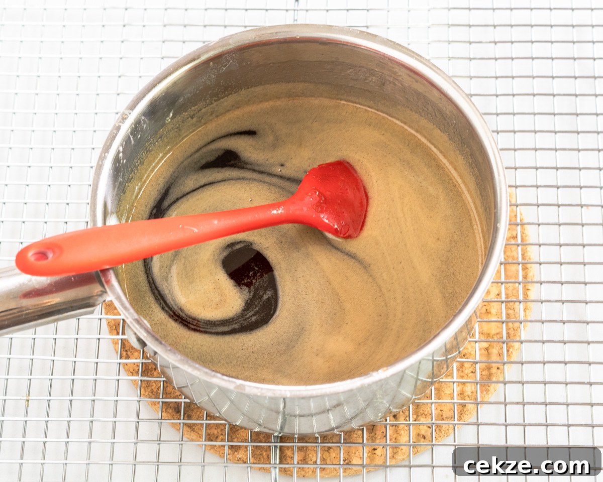 Authentic Cuban Rum Cake Recipe: Moist Drunken Cake with Rum Glaze 6 A saucepan filled with Cuban Rum Syrup for infusing rum cakes. Hostess At Heart