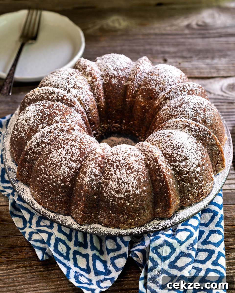 Authentic Cuban Rum Cake Recipe: Moist Drunken Cake with Rum Glaze 10 Angled top down view of a moist Cuban Rum Bundt Cake dusted with powdered sugar - Hostess At Heart