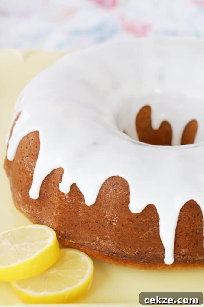A glazed bundt cake on a yellow platter.