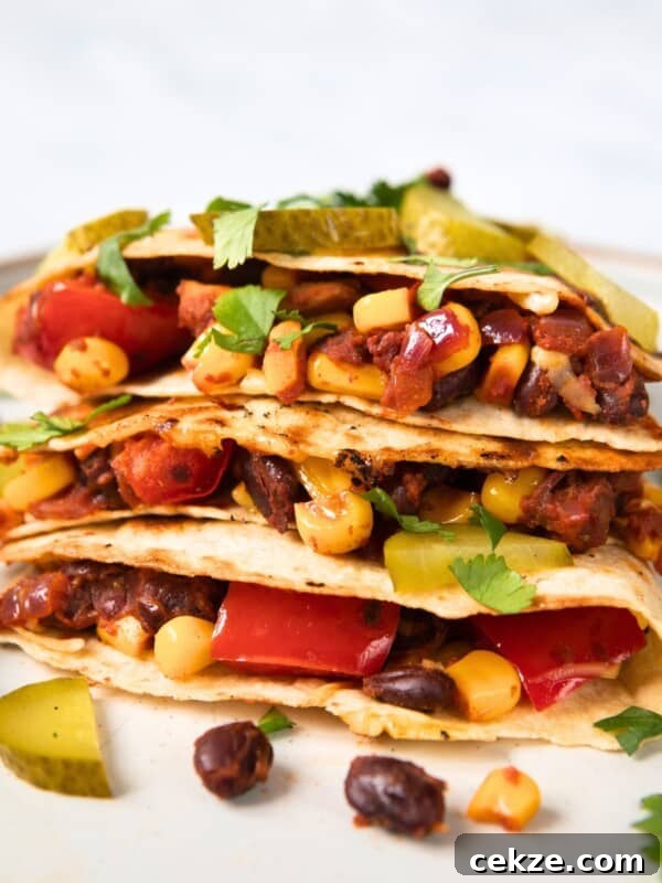 filled black bean quesadillas on a white plate.