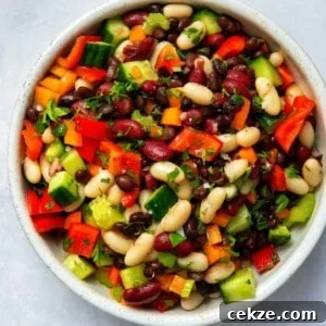 mixed bean salad in large bowl on white surface