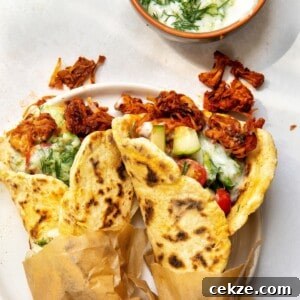 Two vegan gyros served on a plate.
